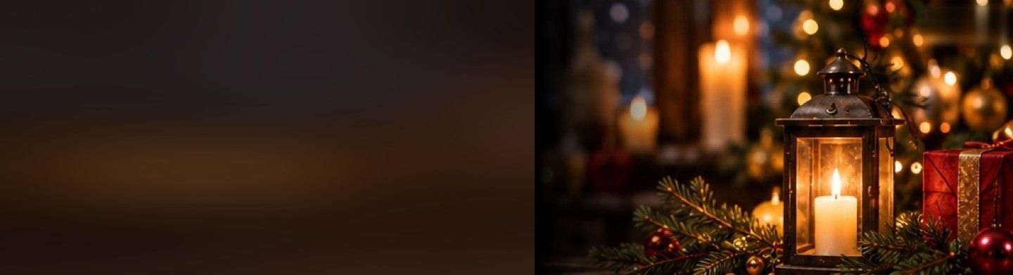 A lit lantern, pine branches and a red gift on a table in a candlelit room