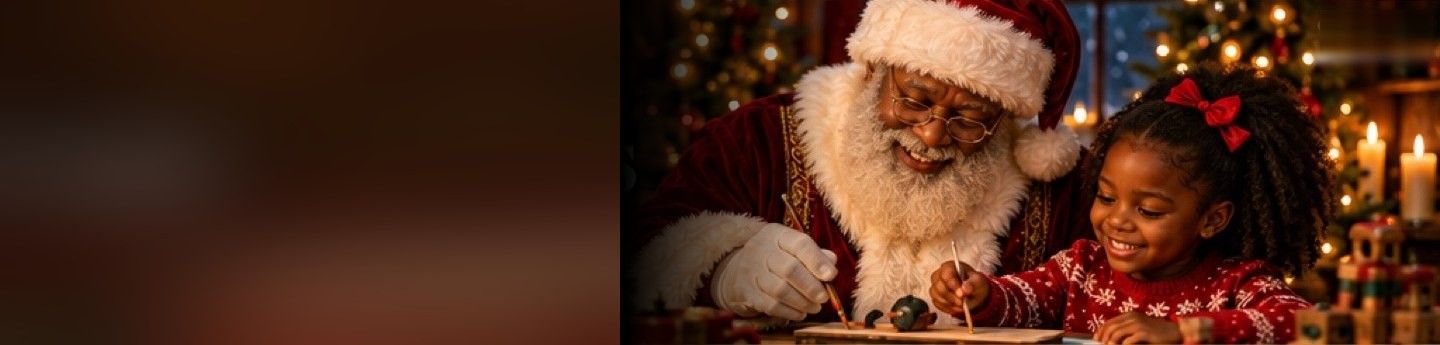 Santa helping a smiling girl write at his desk